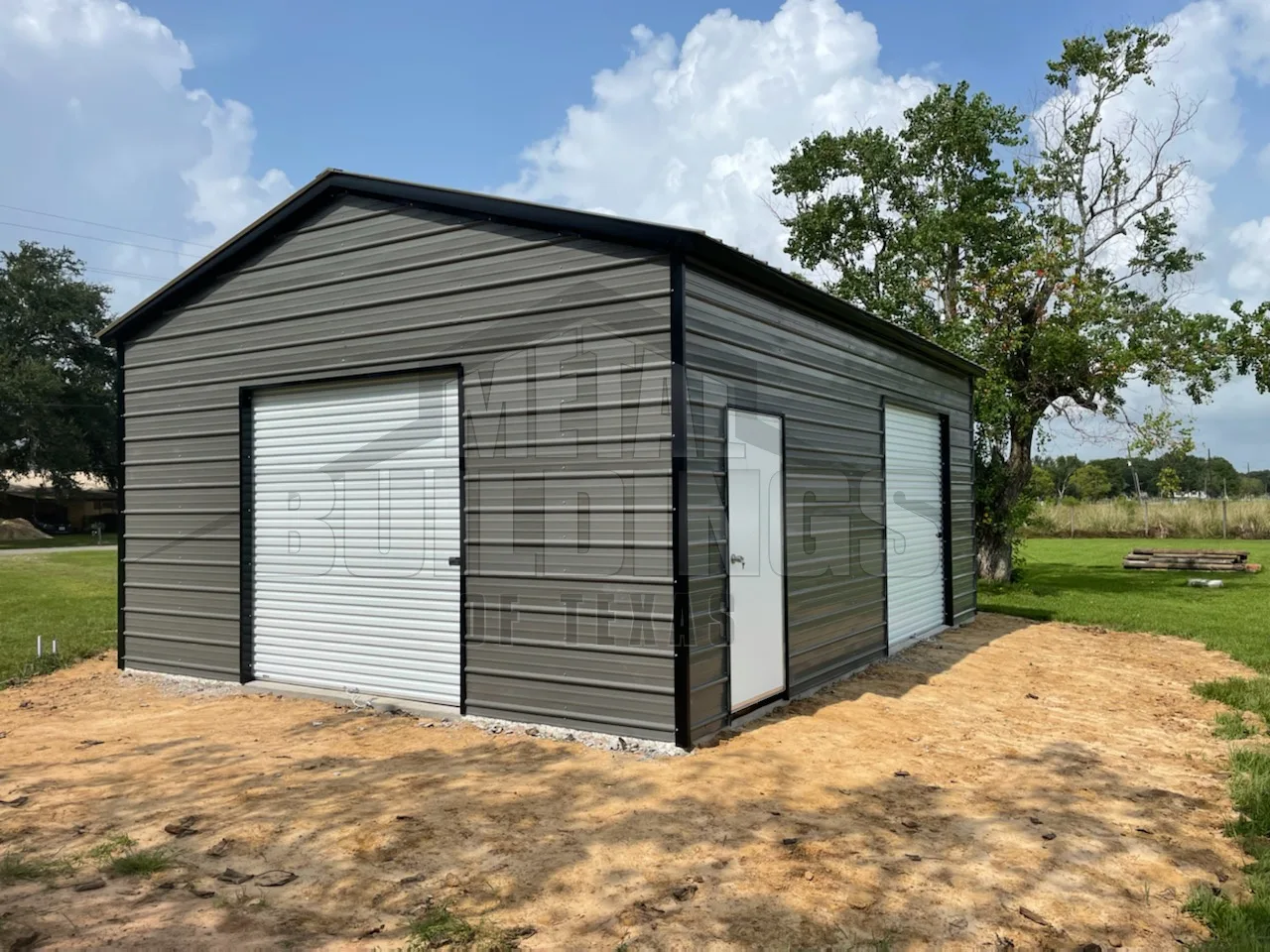 Gray metal garage with overhead doors on two sides
