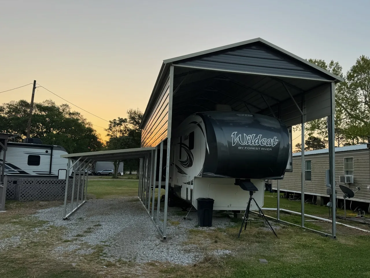 Fifth-wheel trailer beneath a tall metal cover