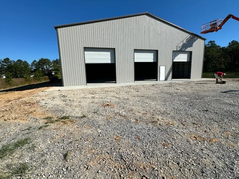 Large metal building with three overhead doors