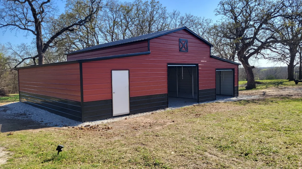 Red metal building with several door openings